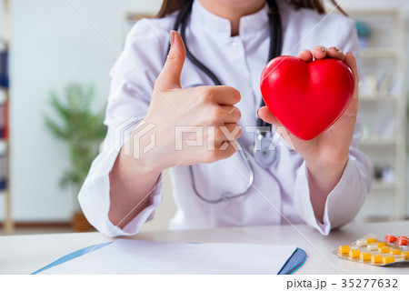 Doctor cardiologist with red heart in the hospital 35277632