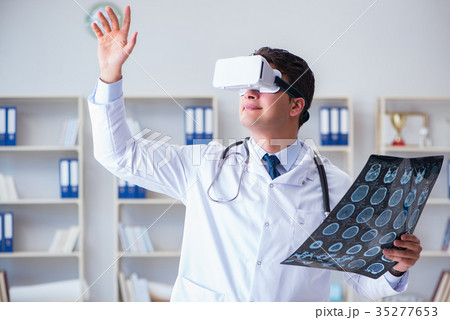 Young doctor looking at MRI scan through VR 35277653