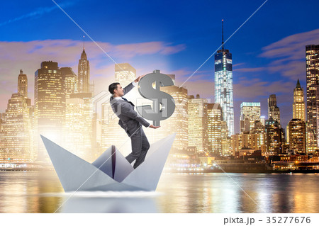 Businessman holding dollar riding paper ship boat 35277676