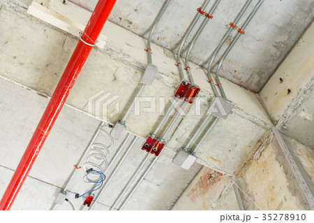 fire sprinkler on red pipe hanging from ceiling  fire sprinkler on red pipe hanging from ceiling  35278910