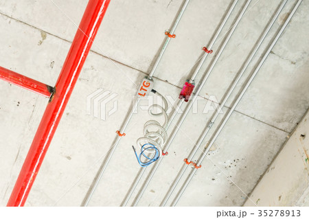fire sprinkler on red pipe hanging from ceiling  35278913