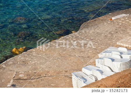 Plastic Poolside Chairs in a pile Plastic Poolside Chairs in a pile 35282173