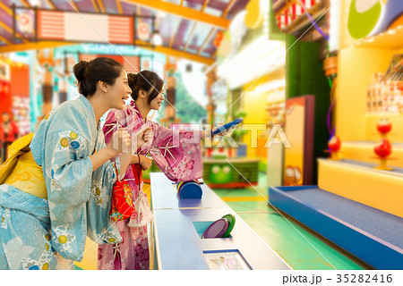 cheerful young woman wearing traditional kimono 35282416
