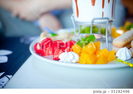 chocolate fondue with fruits in blue pot chocolate fondue with fruits in blue pot 35282496
