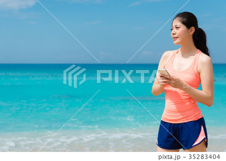 happy beautiful lady holding mobile cell phone happy beautiful lady holding mobile cell phone 35283404