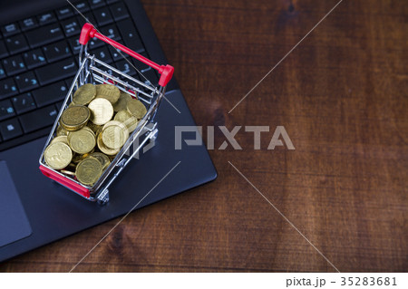 Shopping trolley with coins on a laptop 35283681
