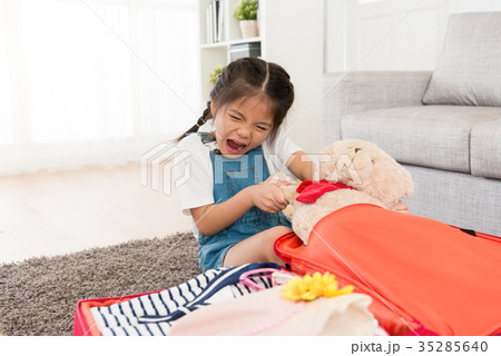 lovely little girl trying to pull her teddy bear 35285640