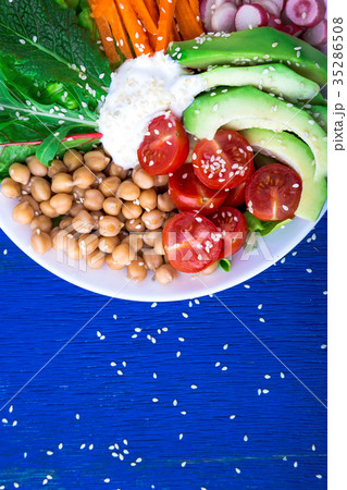 Vegan buddha bowl on blue wooden background Vegan buddha bowl on blue wooden background 35286508