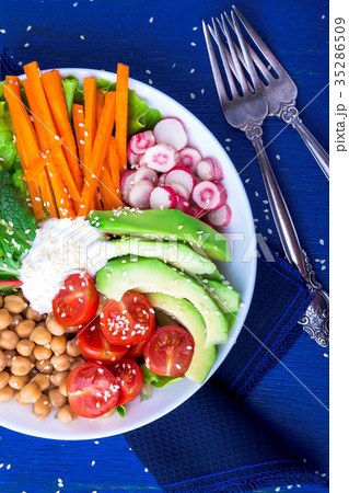 Vegan buddha bowl on blue wooden background Vegan buddha bowl on blue wooden background 35286509