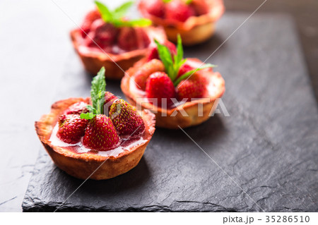 Homemade strawberries tarts on slate plate Homemade strawberries tarts on slate plate 35286510
