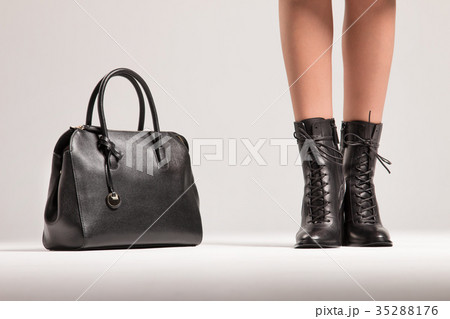 The girl's legs are in shoes and the bag 35288176