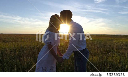 Young beautiful couple in a wheat field Young beautiful couple in a wheat field 35289328