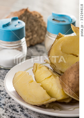 Cooked potatoes on the plate with salt and pepper 35294818