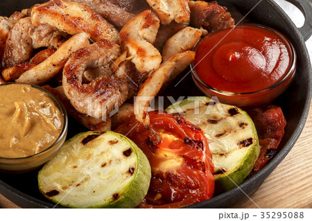 Fresh fried meat with vegetables sauce and mustard Fresh fried meat with vegetables sauce and mustard 35295088