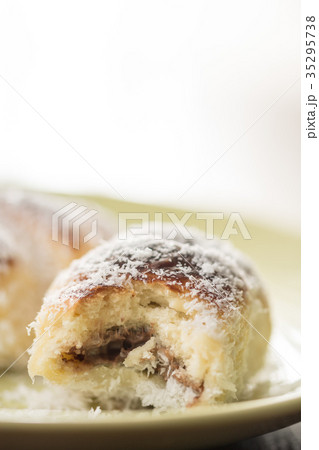 Closeup baked rolls with coconut on the plate 35295738