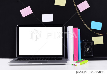 Workspace with laptop, camera, sticky notes. 35295893