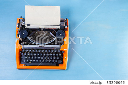 Workspace with vintage orange typewriter Workspace with vintage orange typewriter 35296066