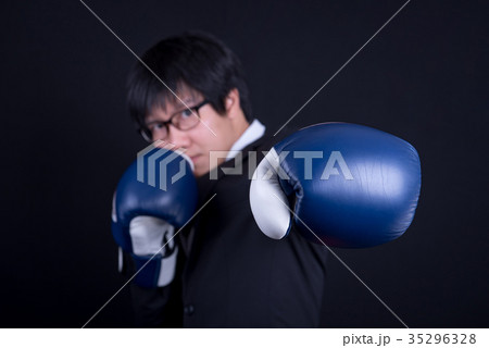 young business man wearing suit with boxing gloves 35296328