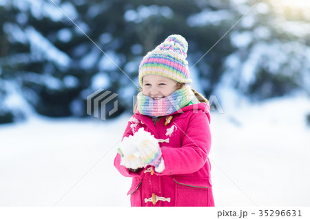 Child playing with snow in winter. Kids outdoors. Child playing with snow in winter. Kids outdoors. 35296631
