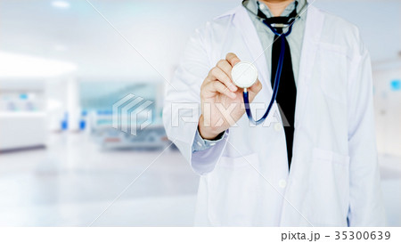 Doctor holding a stethoscope on Hospital ward Doctor holding a stethoscope on Hospital ward 35300639