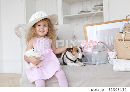 Charming little girl posing with dog Charming little girl posing with dog 35303132