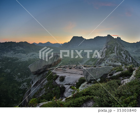 Hanging stone lies on sloping surface of mountain Hanging stone lies on sloping surface of mountain 35303840