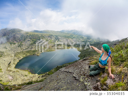 Girl enjoy a beautiful mountain lake, in the 35304035