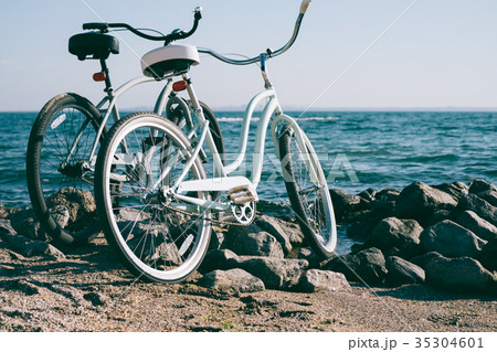 Two retro bike on the beach against the blue sea 35304601