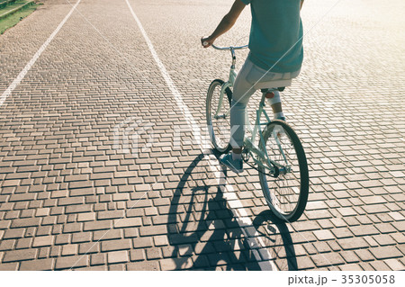 Sporty young girl riding a bicycle Sporty young girl riding a bicycle 35305058
