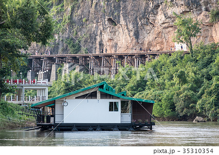 House floating on river kwai with ancient railway 35310354