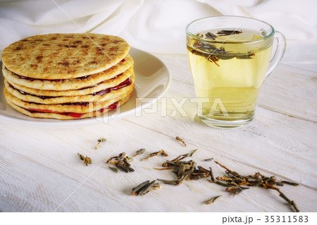 cup of green tea and pancakes with jam 35311583