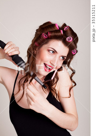 girl with hair curlers talking on the phone and 35315211