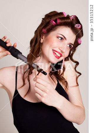 girl with hair curlers talking on the phone and 35315212