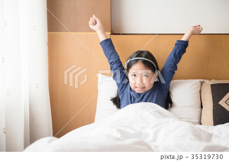 Asian cute girl wakes up and stretching on morning Asian cute girl wakes up and stretching on morning 35319730