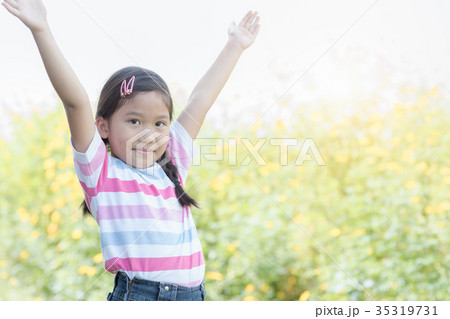 Happy cute girl smiling woman in flower field Happy cute girl smiling woman in flower field 35319731