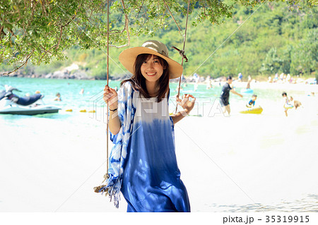 girl sit on swing under the tree at beach girl sit on swing under the tree at beach 35319915