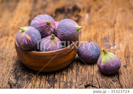 A few figs in a bowl on an old wooden background. A few figs in a bowl on an old wooden background. 35323724