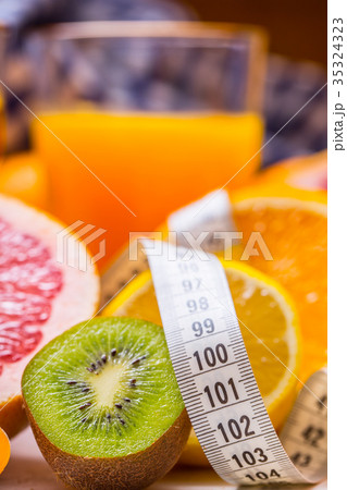 Measure tape and fresh citrus fruit orange lemon. 35324323