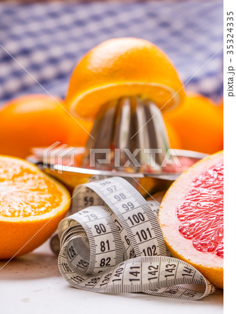 Measure tape and fresh citrus fruit orange lemon. Measure tape and fresh citrus fruit orange lemon. 35324335