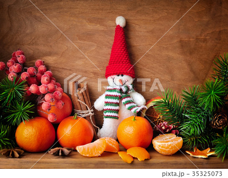 Snowman with tangerines and branches of fir Snowman with tangerines and branches of fir 35325073