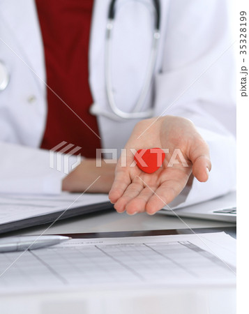 Unknown female doctor with stethoscope holding 35328199