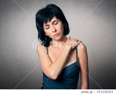 Woman has a neck or shoulder pain 35328303