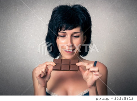 Pretty woman eating chocolate 35328312