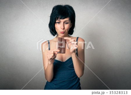 Pretty woman eating chocolate 35328313