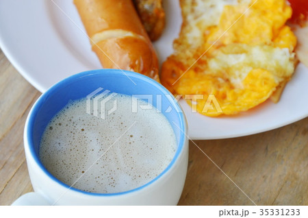 fried egg with sausage dressing ketchup and coffee fried egg with sausage dressing ketchup and coffee 35331233