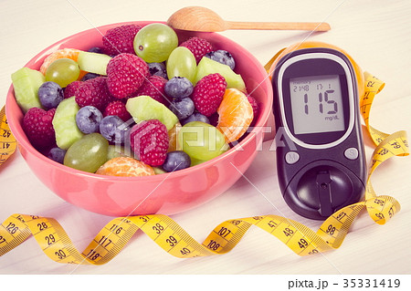 Fresh fruit salad, glucometer and centimeter 35331419