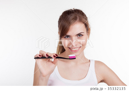 girl holding a toothbrush smiles girl holding a toothbrush smiles 35332135