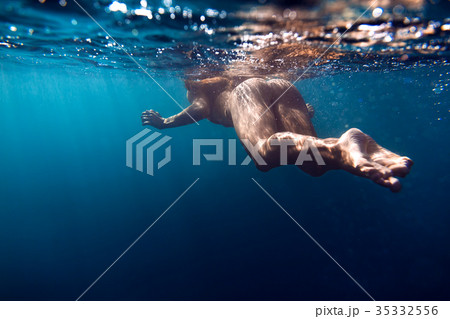 Woman with perfect body swimming in sea. 35332556
