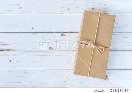 Top view above brown gift box on wooden Top view above brown gift box on wooden 35333157