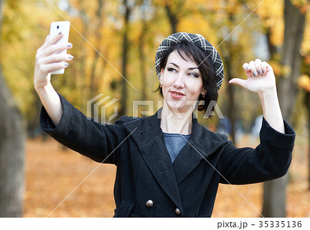 selfie of girl in autumn city park, yellow leaves 35335136
